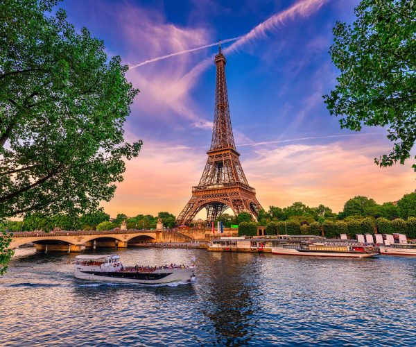Paris Eiffel Tower and river Seine at sunset in Paris, France. Eiffel Tower is one of the most iconic landmarks of Paris.