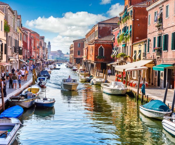 Island murano in Venice Italy. View on canal with boat and motorboat water. Picturesque landscape.